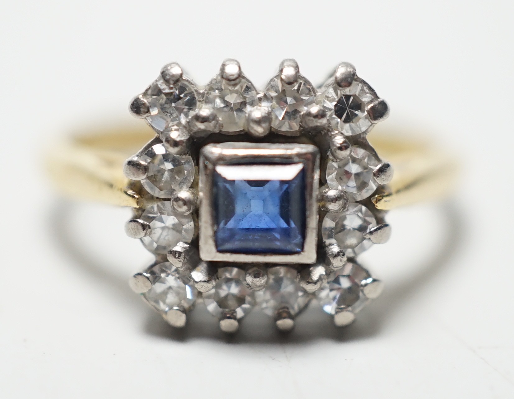 A 1960's 18ct gold, sapphire and diamond set square cluster ring, size N, gross 4.2 grams.